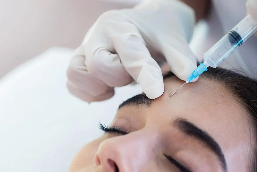 woman recieving injection above her brow